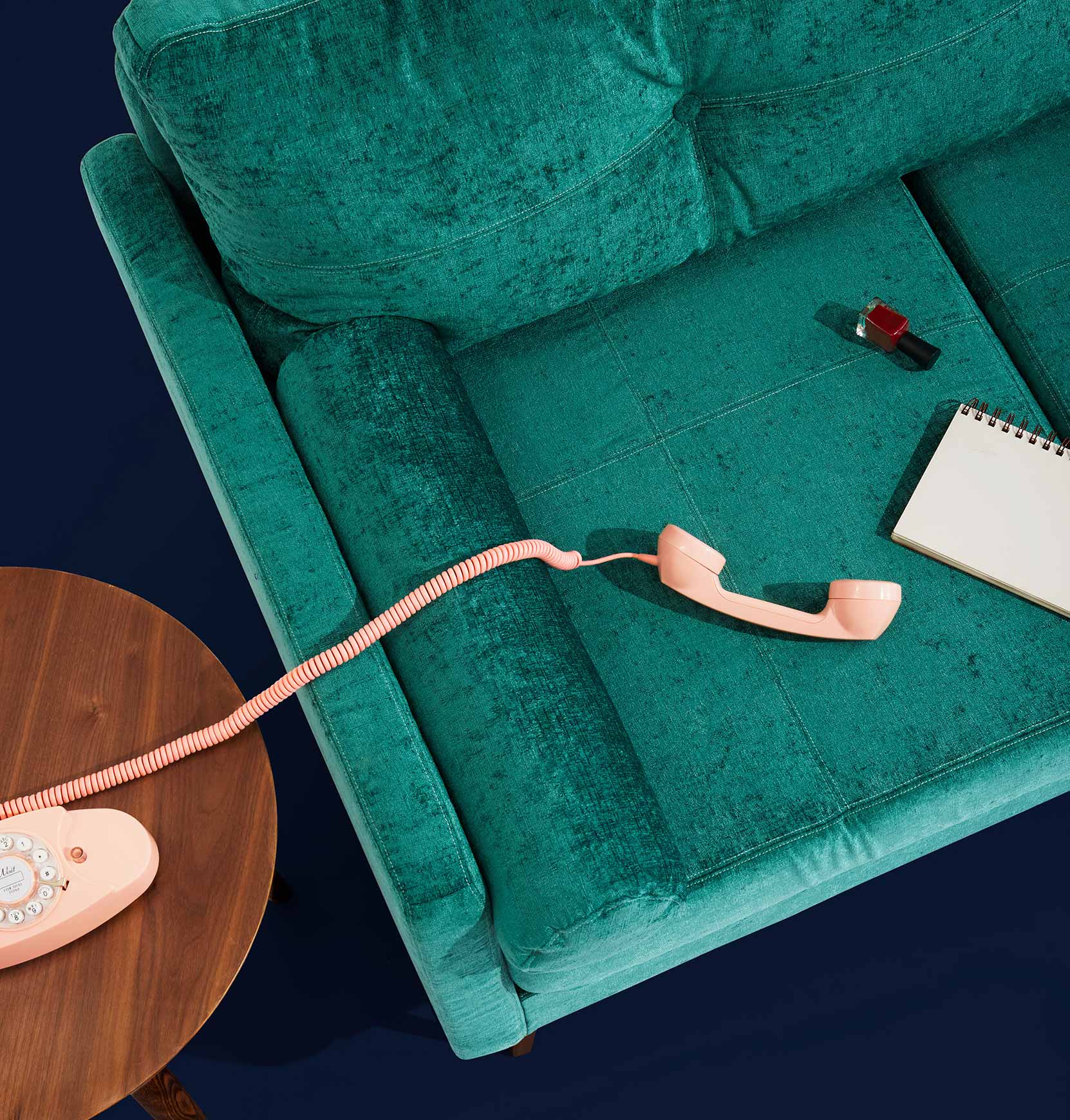 Phone and Notebook on Green Couch